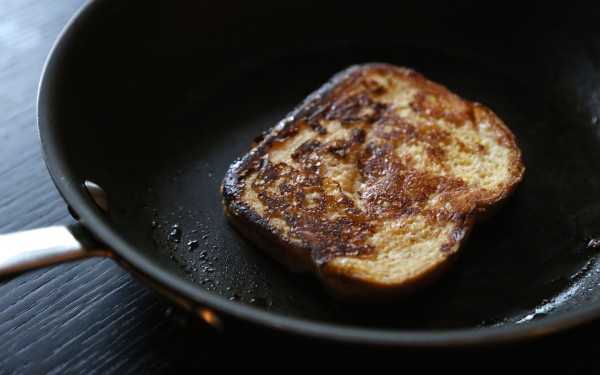 French toast sizzling in a pan.
