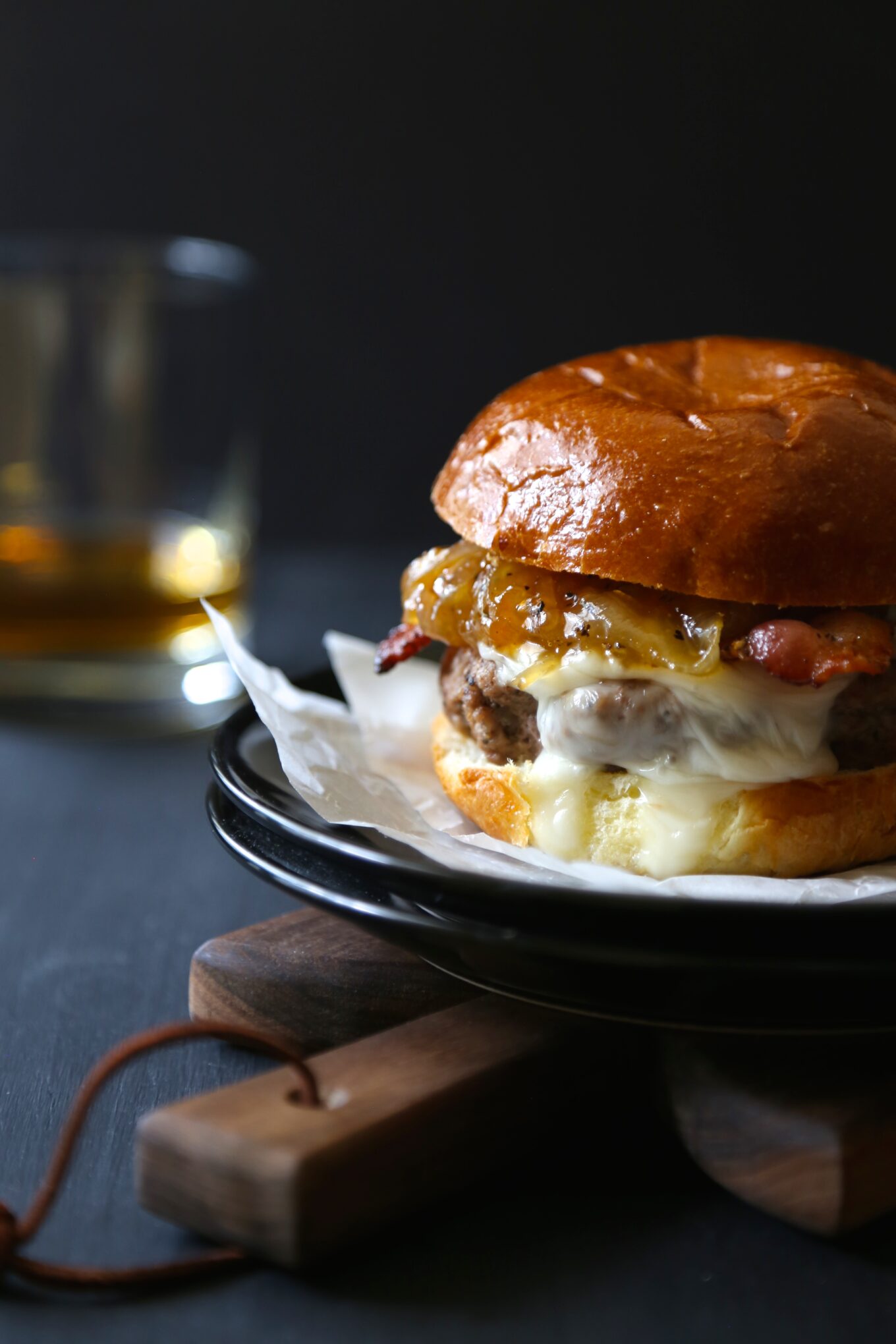bacon and brie burger with spicy peach caramelized onions