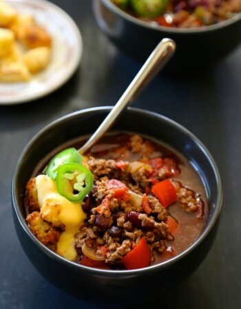 slow cooker tijuana chili with jalapeno cornbread croutons & queso