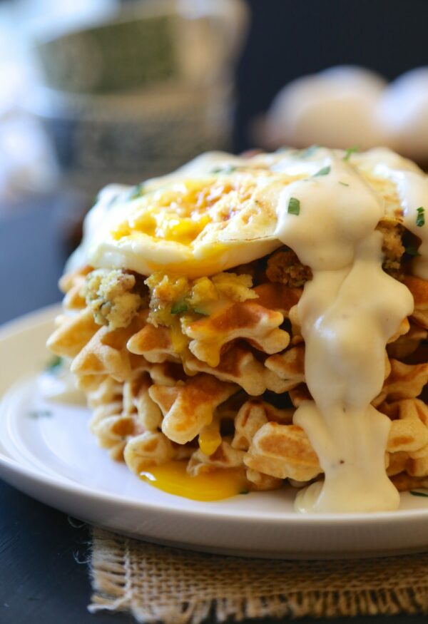 Stuffing waffles with Thanksgiving leftovers, topped with fried egg & gravy .