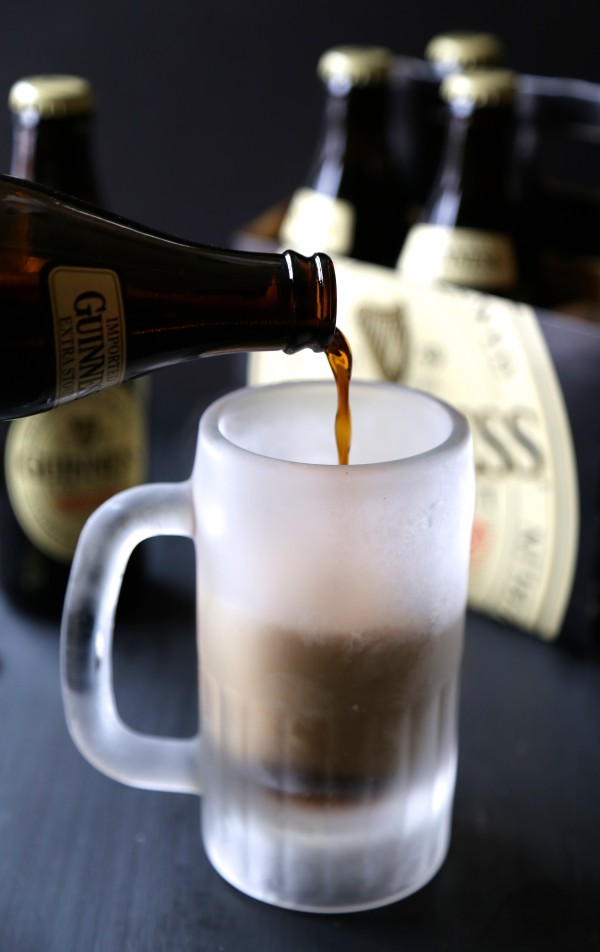 Pouring a Guinness beer into a frosty glass.