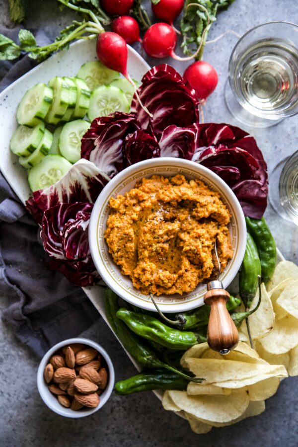 carrot dip in bowl with assorted food