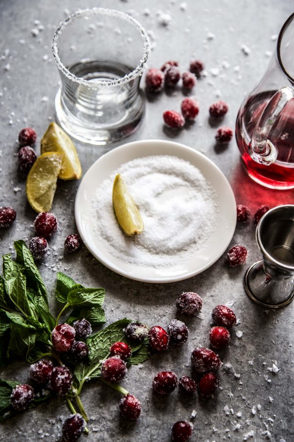 ingredients for a cranberry margarita on a board