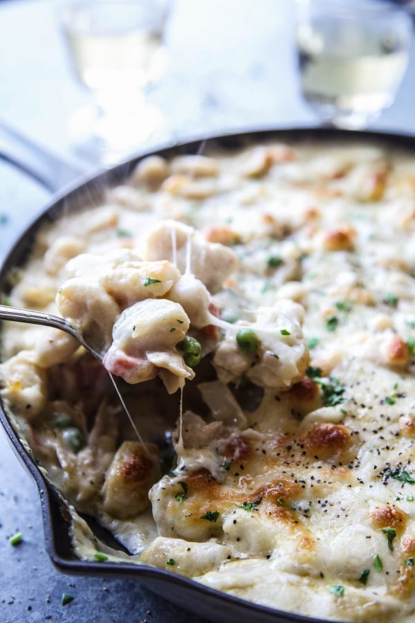 Spoonful of crustless chicken pot pie topped with gnocchi.