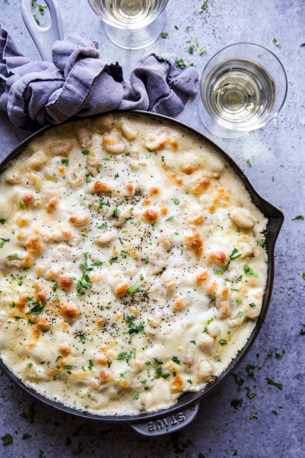 Crustless chicken pot pie on a table with two glasses of wine.