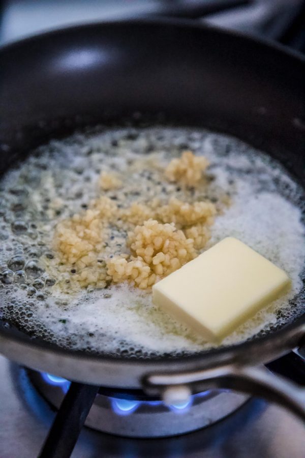 Garlic and butter sizzling in a skillet.