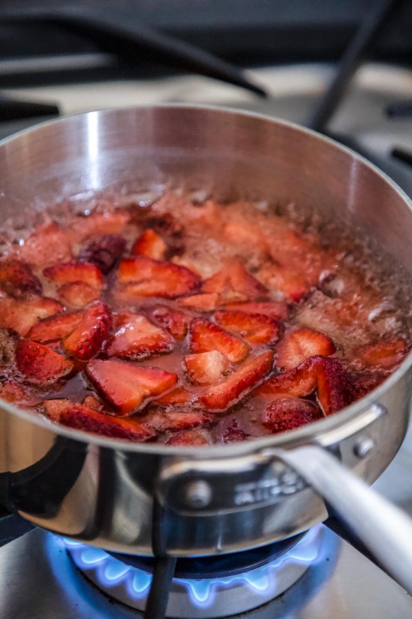 strawberries in a pan being boiled to turn into jam