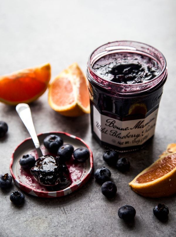 blueberry preserve and oranges on a table