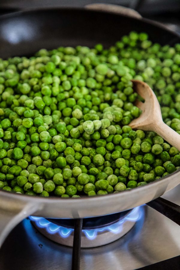 peas cooking in a skillet
