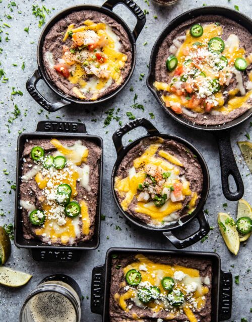 Ultimate Black Bean Dip in several skillets on a table