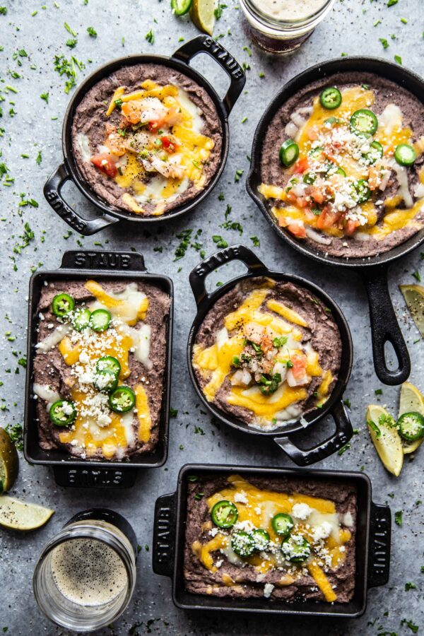 Ultimate Black Bean Dip in several skillets on a table