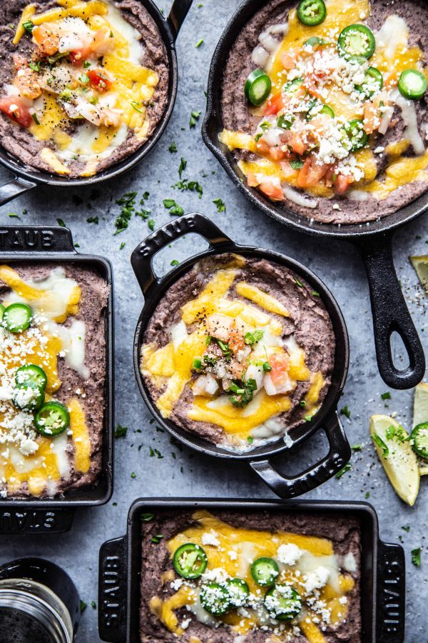 Ultimate Black Bean Dip in several skillets on a table