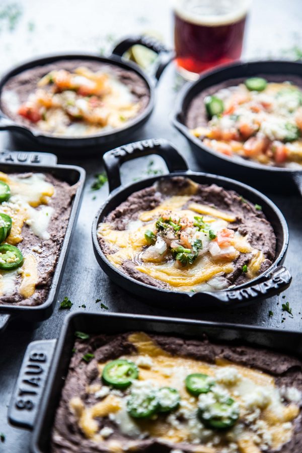 Ultimate Black Bean Dip in several skillets on a table