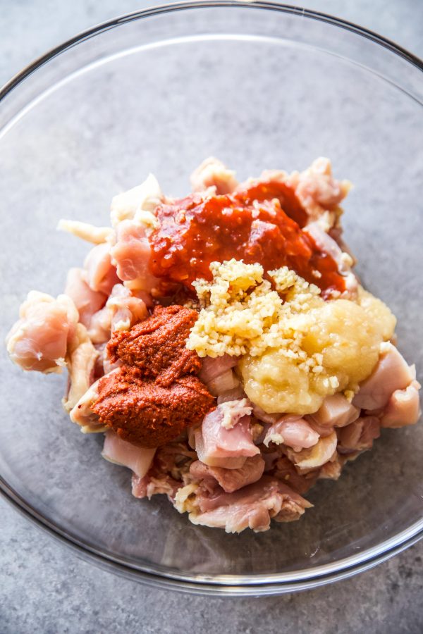 thai chicken spices mixed with chicken in a bowl