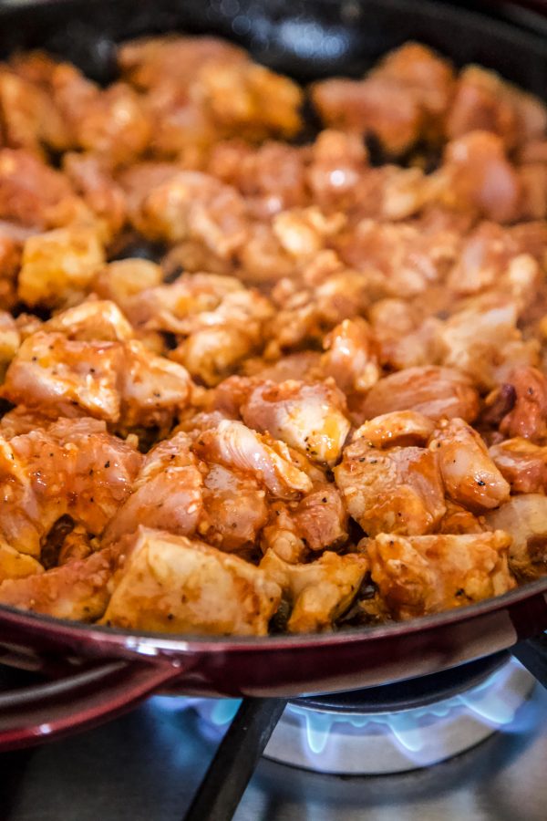 thai chicken cooking in a skillet