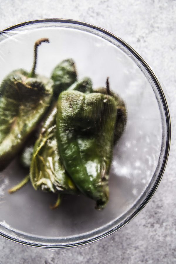 poblano chilles steaming in a bowl