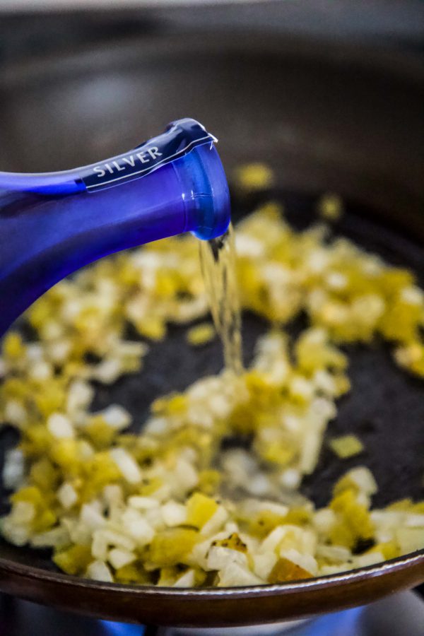 tequila being poured into a skillet