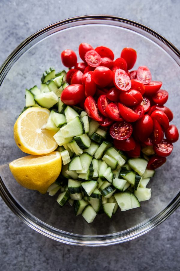 grape tomatoes, cucumbers, lemons in a bowl