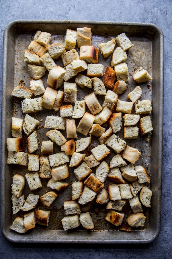 roasted baguette cubes on a baking sheet