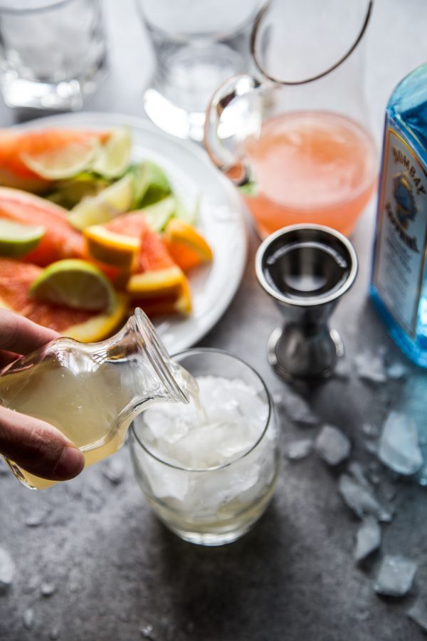 simple syrup being poured into a cocktail glass