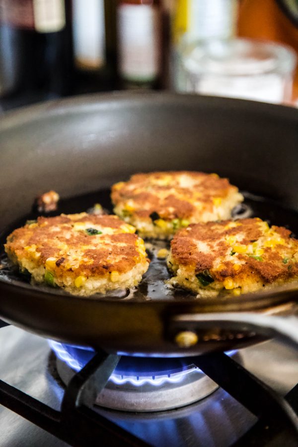 crab cakes cooking in a skillet