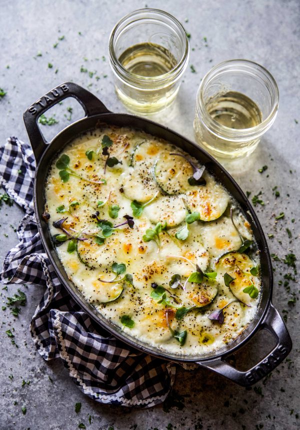 Cheesy Scalloped Zucchini in a skillet.