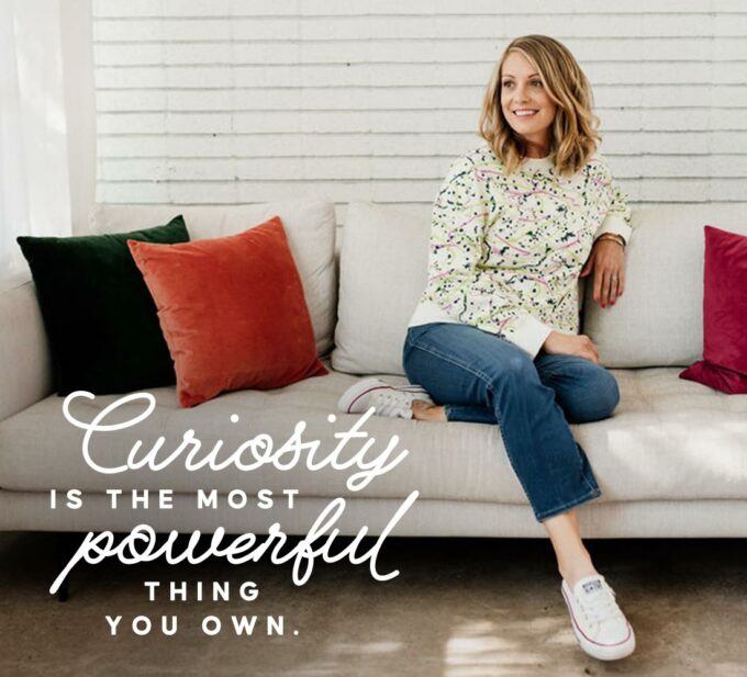 Lauren on a couch with text overlay: Curiosity is the most powerful thing you own.