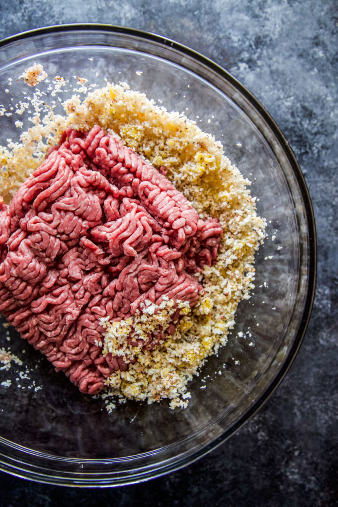 ground beef with ingredients in a mixing bowl