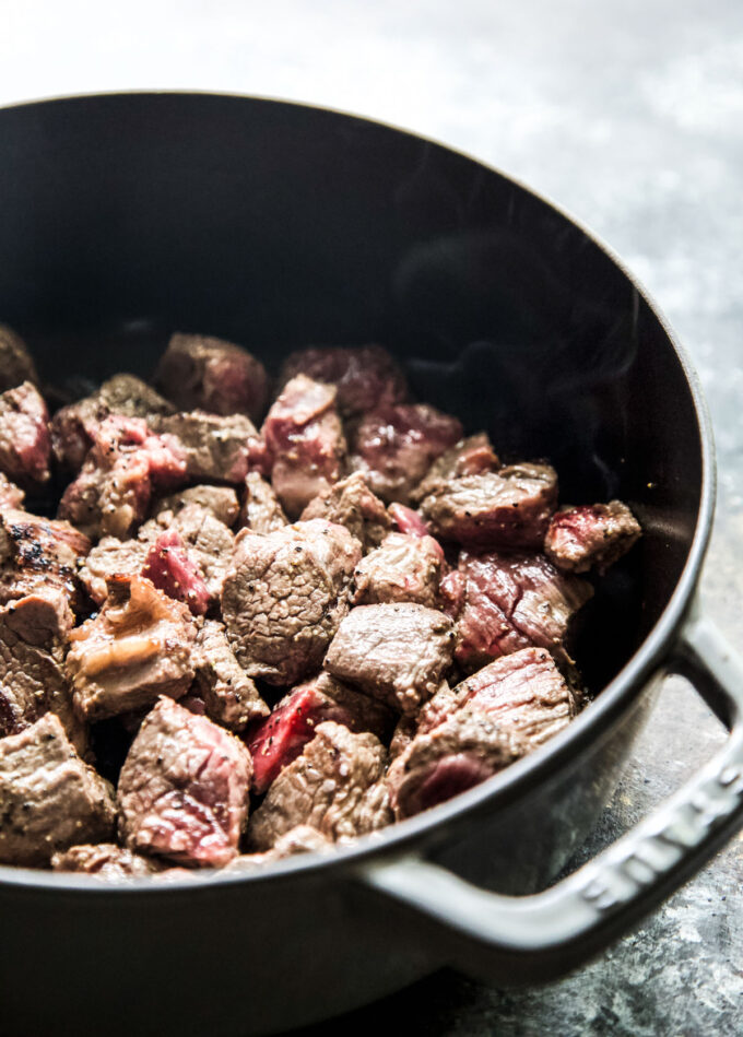 beef stew meat cooking in a skillet
