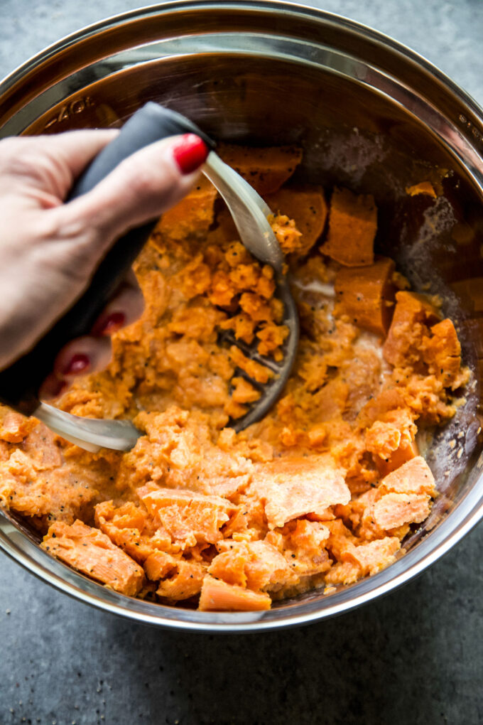 sweet potatoes being mashed