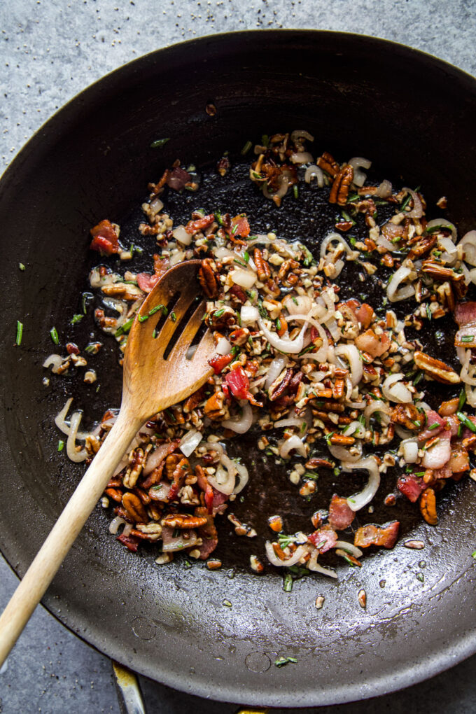 bacon pecan topping being sauteed in a pan