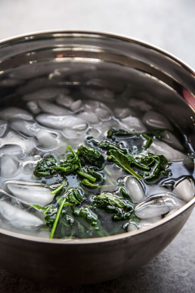 cooked spinach in an ice bath