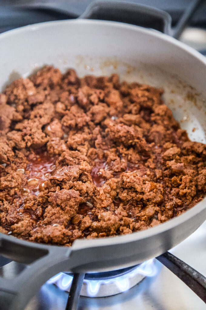 Ground chorizo cooking in a skillet