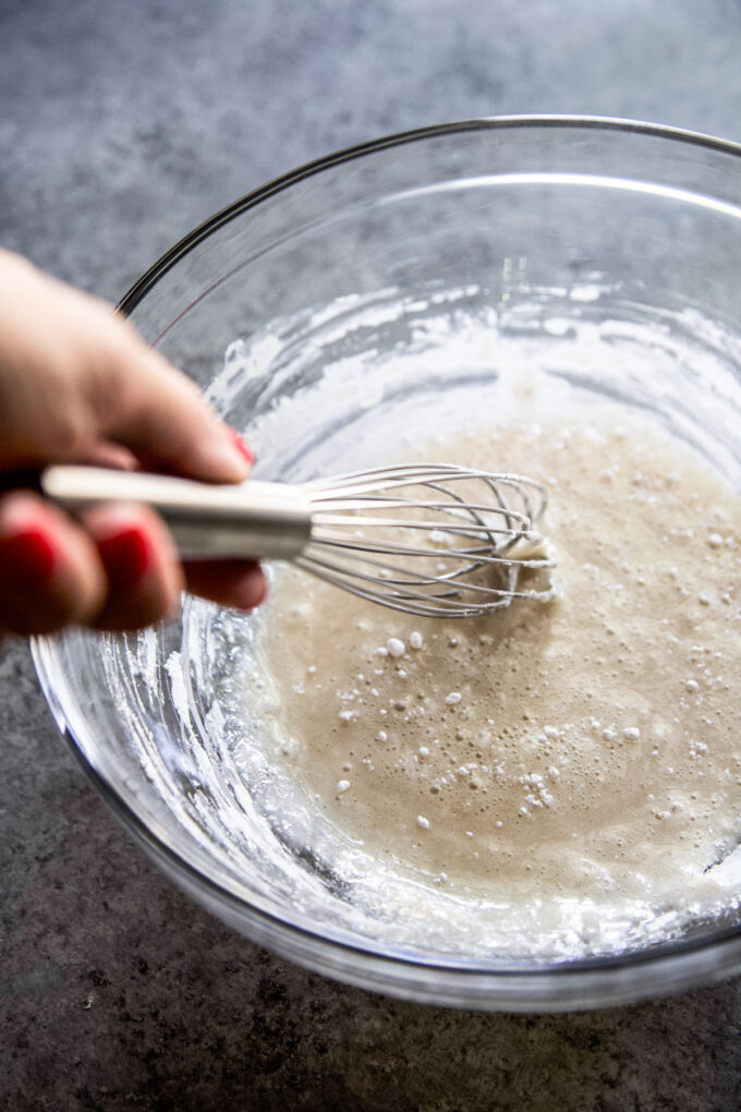 whisking the maple glaze together in a bowl