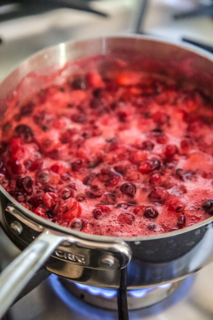 fresh cranberries sauting in a skillet
