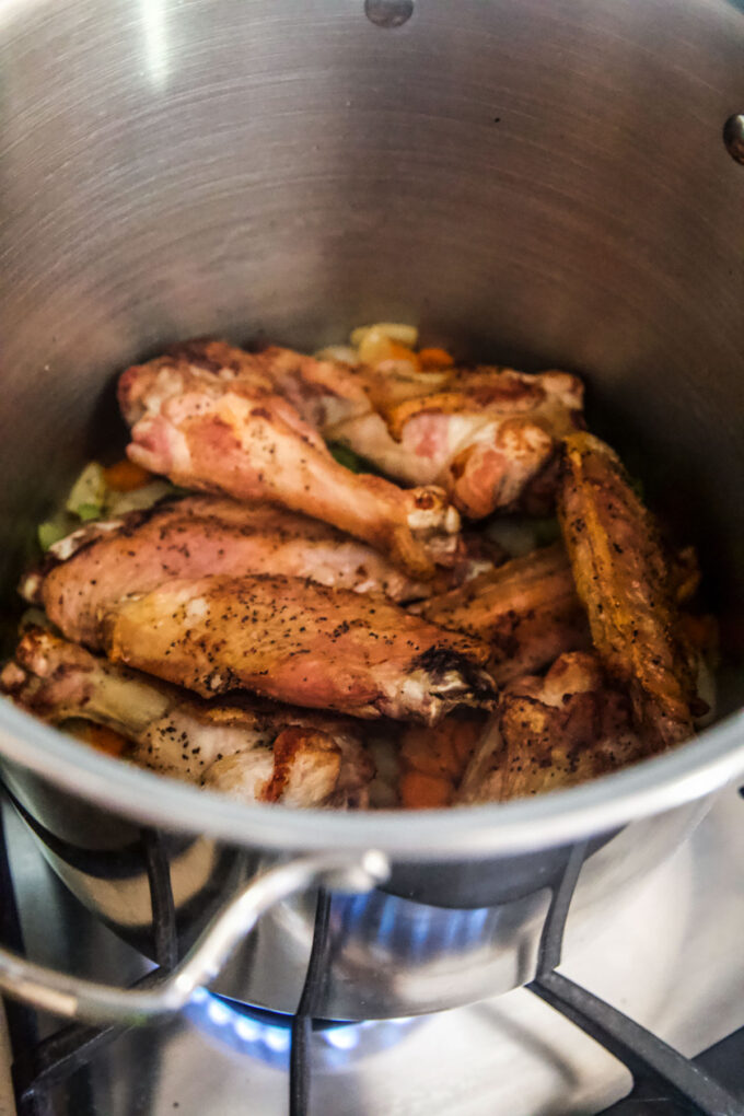 turkey wings into a stock pot with vegetables