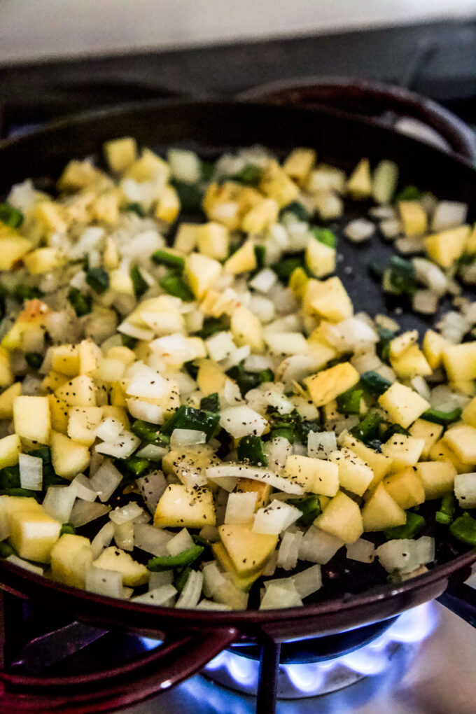 apple and poblano pepper sauting in a skillet