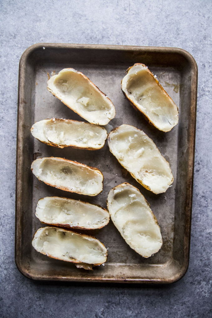 baked potatoes sliced in half and potato innards removed