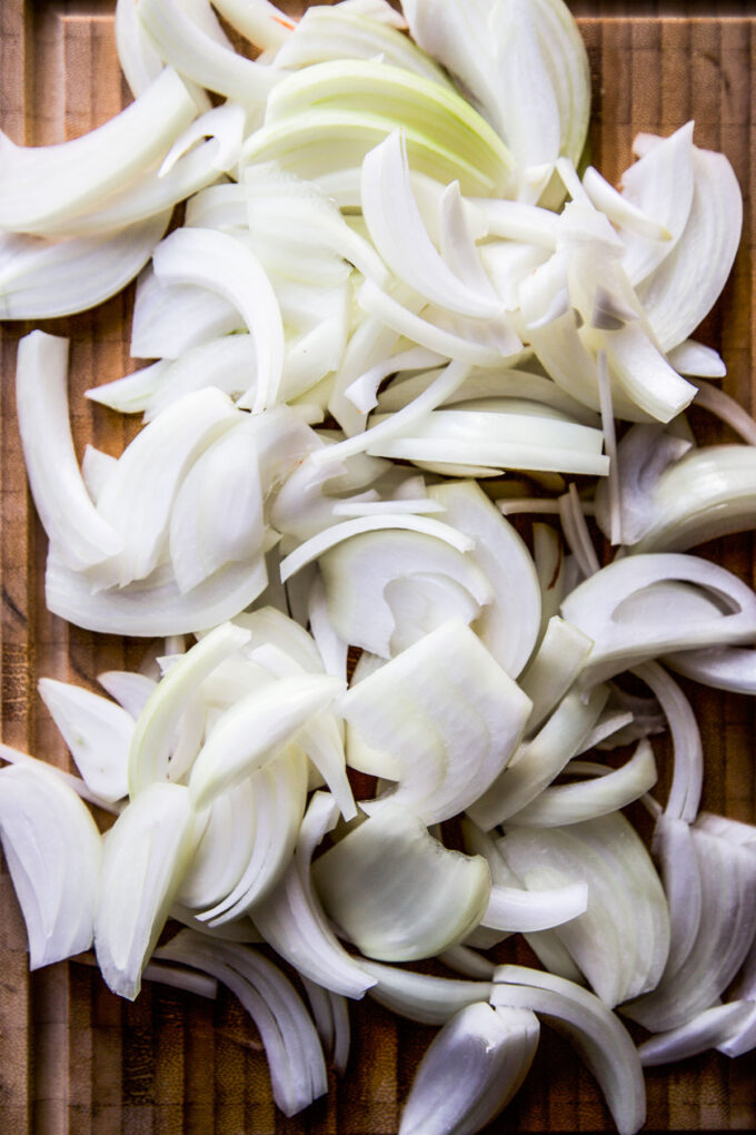 raw onions on a cutting board