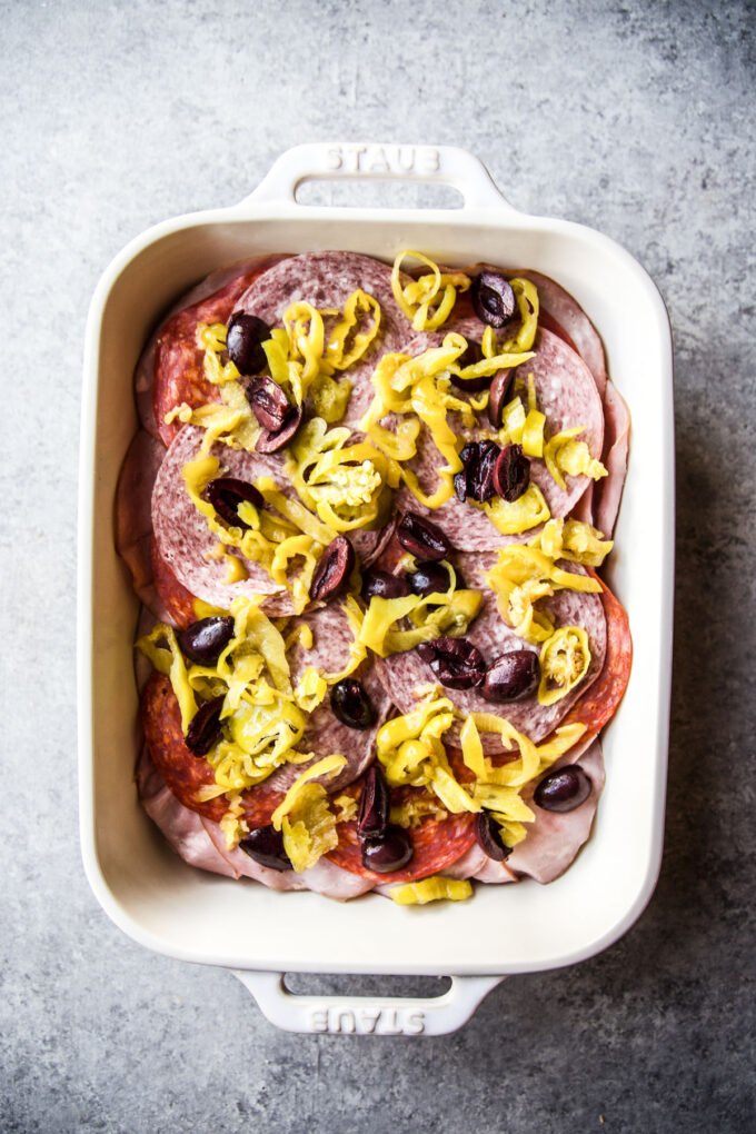 layered deli meat and pickled vegetables in baking dish