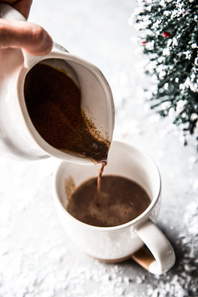 easy tahini hot chocolate being poured into a mug