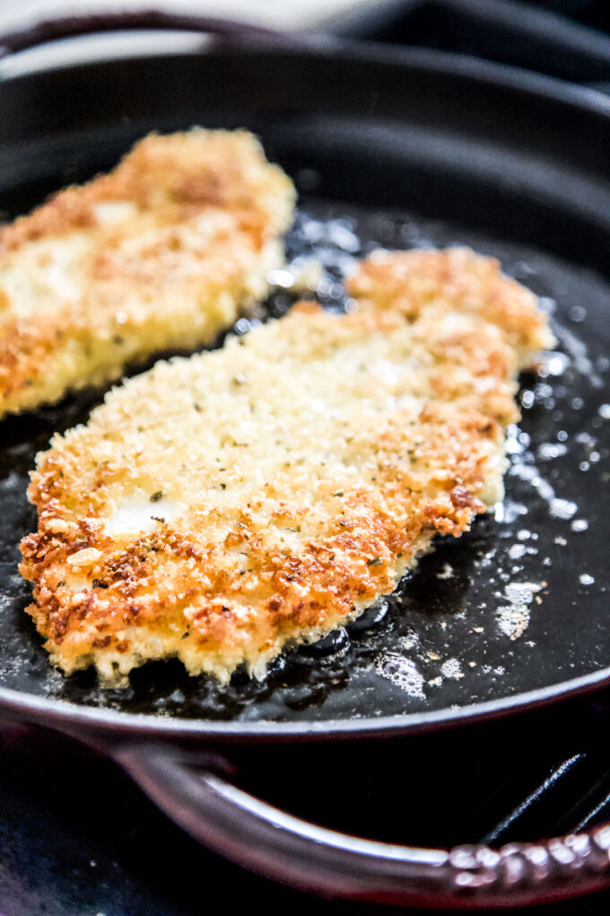 chicken parmesan being cooked in a skillet