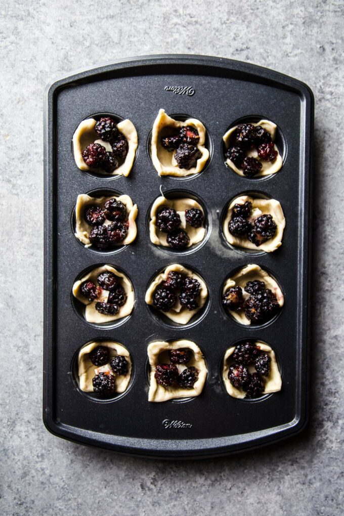 blackberries and brie in muffin tin
