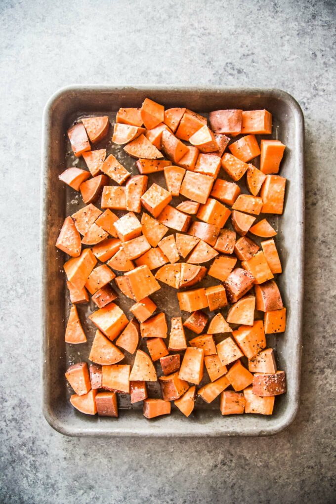 sweet potatoes cubed on a baking sheet