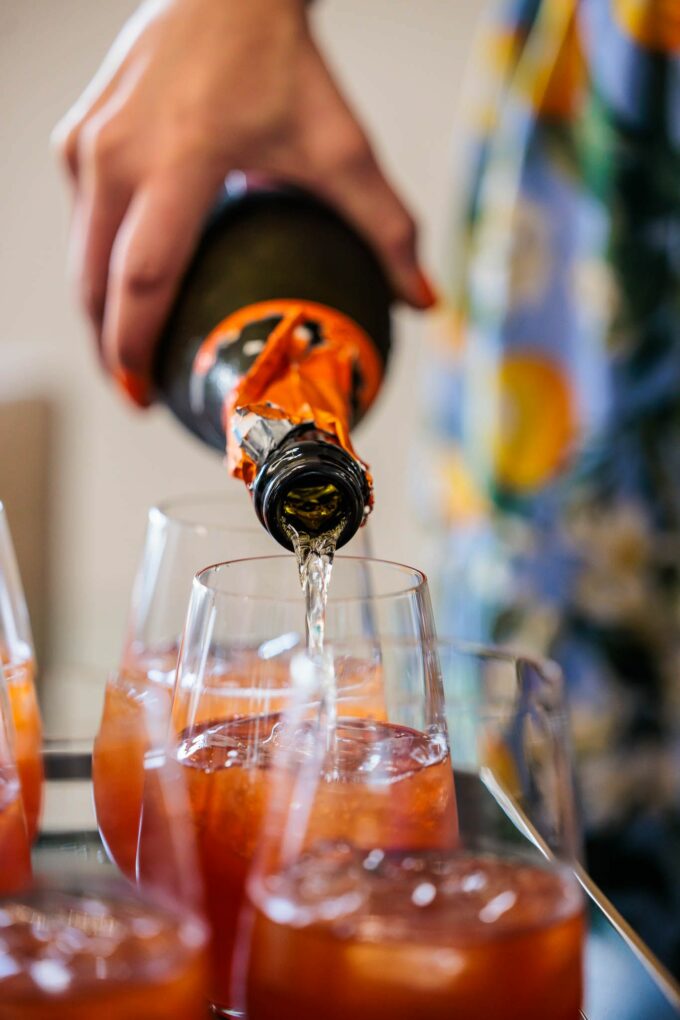 pour champange into cocktail glasses