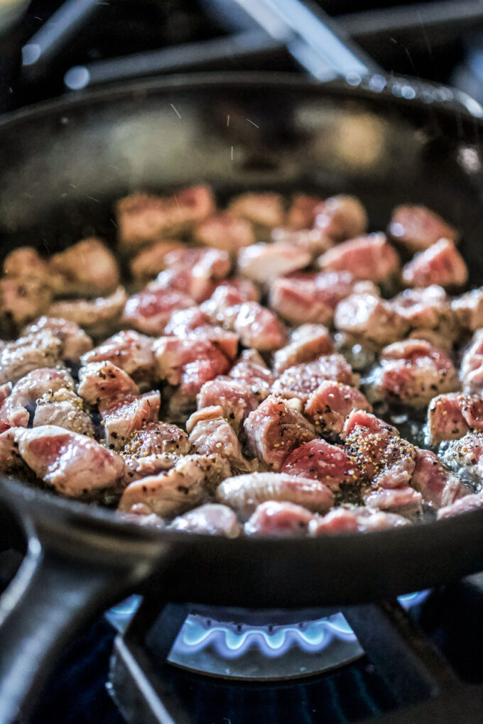 lamb roast cooking in a skillet